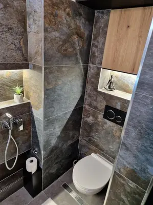 a bathroom with a toilet and a sink at Biblioteka Spa Suite in Novi Beograd