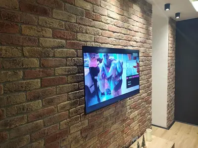 a flat screen tv mounted on a brick wall at Blackwood Hill in Belgrade