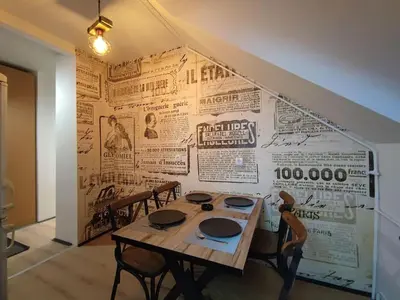 a room with a table and a wall with newspapers at Blackwood Hill in Belgrade