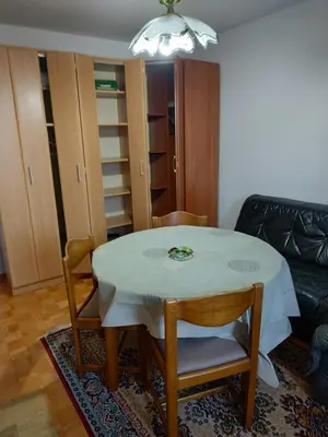 a dining room with a table and chairs and a couch at Vojin Meljak in Meljak