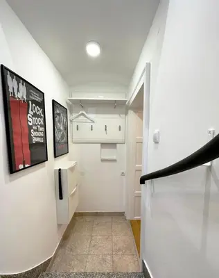 a hallway with a white staircase with a refrigerator at Royal Underground Belgrade in Belgrade