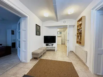 a living room with a television and a couch at Royal Underground Belgrade in Belgrade