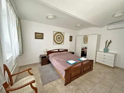 a bedroom with a bed and a desk and a chair at Royal Underground Belgrade in Belgrade