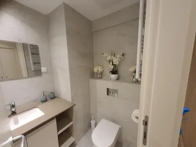 a bathroom with a toilet and a sink and a mirror at Belgrade Waterfront Lux Apartment in Belgrade