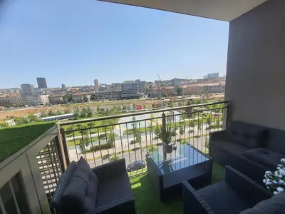 a balcony with couches and a view of a city at Belgrade Waterfront Lux Apartment in Belgrade