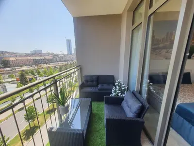 a balcony with chairs and a couch on a building at Belgrade Waterfront Lux Apartment in Belgrade