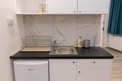 a kitchen with a sink and a counter top at Fair Apartment in Belgrade