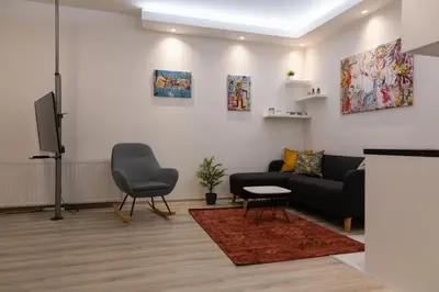 a living room with a couch and a tv at Fair Apartment in Belgrade