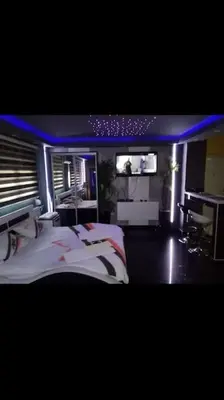 a bedroom with two beds and a flat screen tv at Spa Apartment in Belgrade