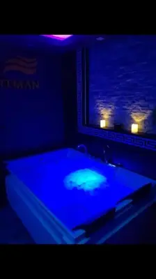 a pool table in a room with a blue light at Spa Apartment in Belgrade