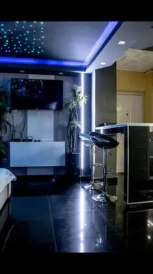 a kitchen with a counter and a stool in a room at Spa Apartment in Belgrade