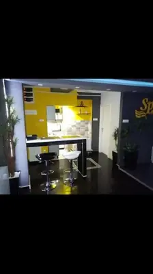a room with a counter and two stools in it at Spa Apartment in Belgrade