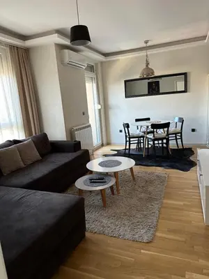 a living room with a couch and a table at Apartman DM in Zvezdara