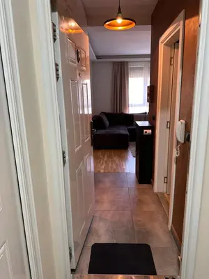 a hallway leading to a living room with a couch at Apartman DM in Zvezdara