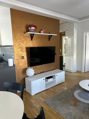 a living room with a flat screen tv on a wall at Apartman DM in Zvezdara