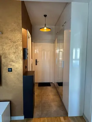 a hallway with a white door and a glass wall at Apartman DM in Zvezdara