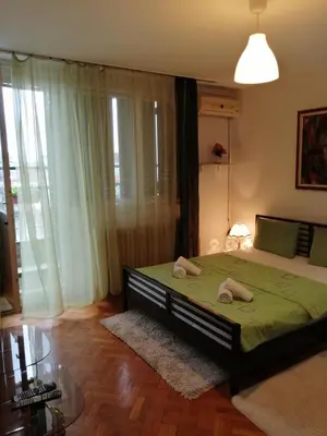 a bedroom with a bed with two towels on it at Apartman Centar in Belgrade