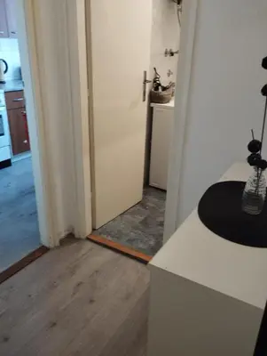 a room with a kitchen and a hallway with a door at Apartman Centar in Belgrade