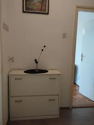 a dresser with a vase on top of it at Apartman Centar in Belgrade