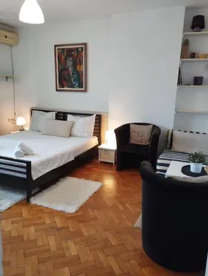a living room with a bed and a couch at Apartman Centar in Belgrade