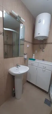 a bathroom with a sink and a mirror at Tid Apartman in Arandjelovac