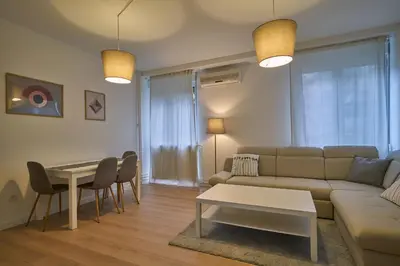 a living room with a couch and a table at Perfect 10 in Belgrade
