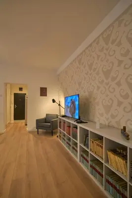 a living room with a couch and a tv and books at Perfect 10 in Belgrade