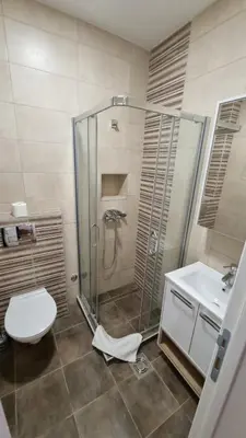 a bathroom with a shower and a toilet and a sink at Apartments near Belgrade Waterfront in Belgrade
