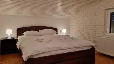 a bedroom with a large bed with two towels on it at Apartments near Belgrade Waterfront in Belgrade