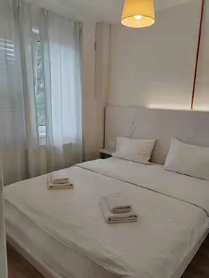 a bedroom with a white bed with two plates on it at Apartments near Belgrade Waterfront in Belgrade