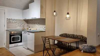 a small kitchen with a table and a dining room at Apartments near Belgrade Waterfront in Belgrade