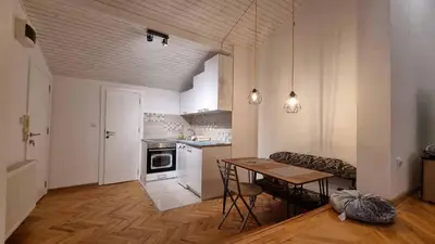a kitchen with a table and a dining room at Apartments near Belgrade Waterfront in Belgrade
