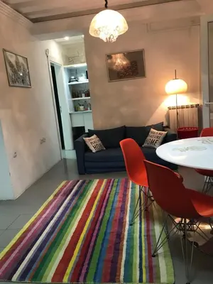 a living room with a couch and a table with chairs at Globetrotter's City Center Modern ᯤ in Belgrade