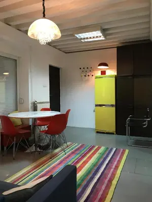 a dining room with a table and chairs and a kitchen at Globetrotter's City Center Modern ᯤ in Belgrade