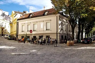 a group of people sitting outside of a building at Globetrotter's City Center Modern ᯤ in Belgrade