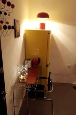 a room with a table with a lamp and a chair at Globetrotter's City Center Modern ᯤ in Belgrade