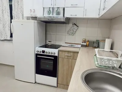 a small kitchen with a stove and a sink at Cozy Family House in Lazarevac