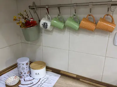 a kitchen counter with cups and mugs on the wall at Cozy Family House in Lazarevac