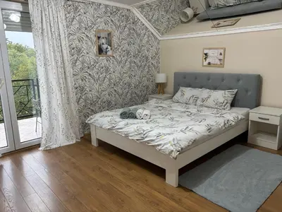 a bedroom with a bed in a room with a window at Cozy Family House in Lazarevac