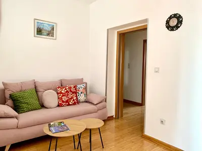 a living room with a couch and a table at City Center Crown Apartment in Belgrade