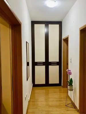 a hallway with a door with a potted plant in it at City Center Crown Apartment in Belgrade