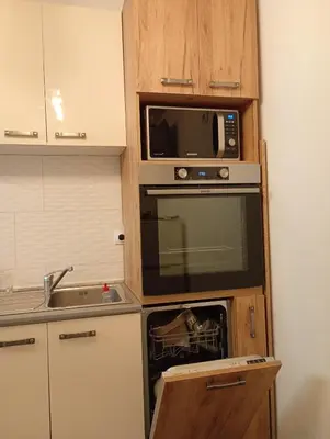 a small kitchen with a microwave and a sink at ODMORKO Zemun in Belgrade