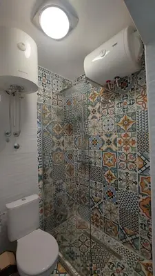 a bathroom with a toilet and a tiled wall at ODMORKO Zemun in Belgrade