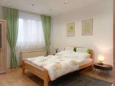 a bedroom with a bed and a window with green curtains at ODMORKO Zemun in Belgrade