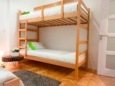 a bedroom with two bunk beds in a room at ODMORKO Zemun in Belgrade