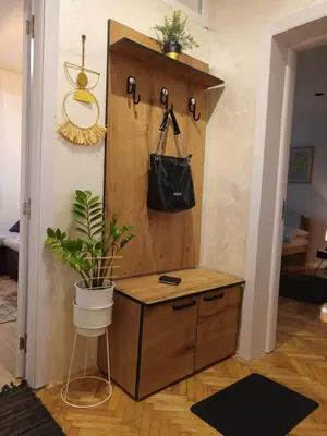 a room with a wooden cabinet with a potted plant at ODMORKO Zemun in Belgrade