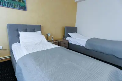 two beds sitting next to each other in a room at Smeštaj Tank, Pančevo in Salaši