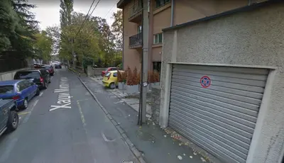 a street with cars parked on the side of a building at Apartment Sofija Vracar in Belgrade
