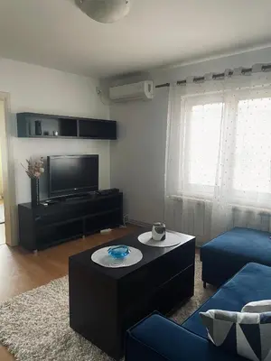 a living room with a couch and a tv at Apartman Bloom in Novi Grad