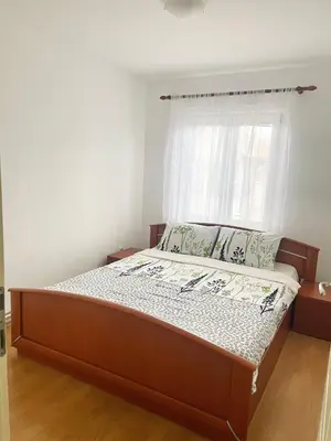a bed in a bedroom with a window at Apartman Bloom in Novi Grad